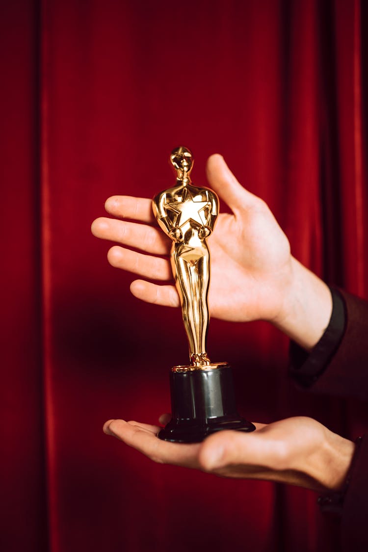 Gold Trophy On Person's Hand