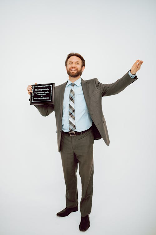 Free Man in Gray Suit Holding Black Card Stock Photo