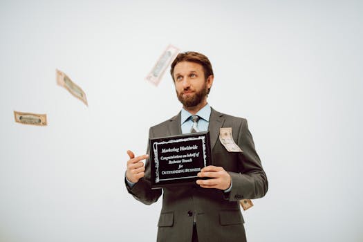 Businessman holding an award plaque, surrounded by falling cash, symbolizing success.