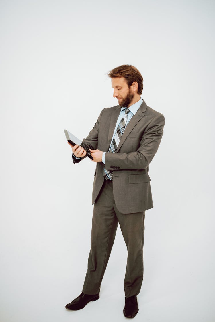 Man In Suit Holding An Award Plaque