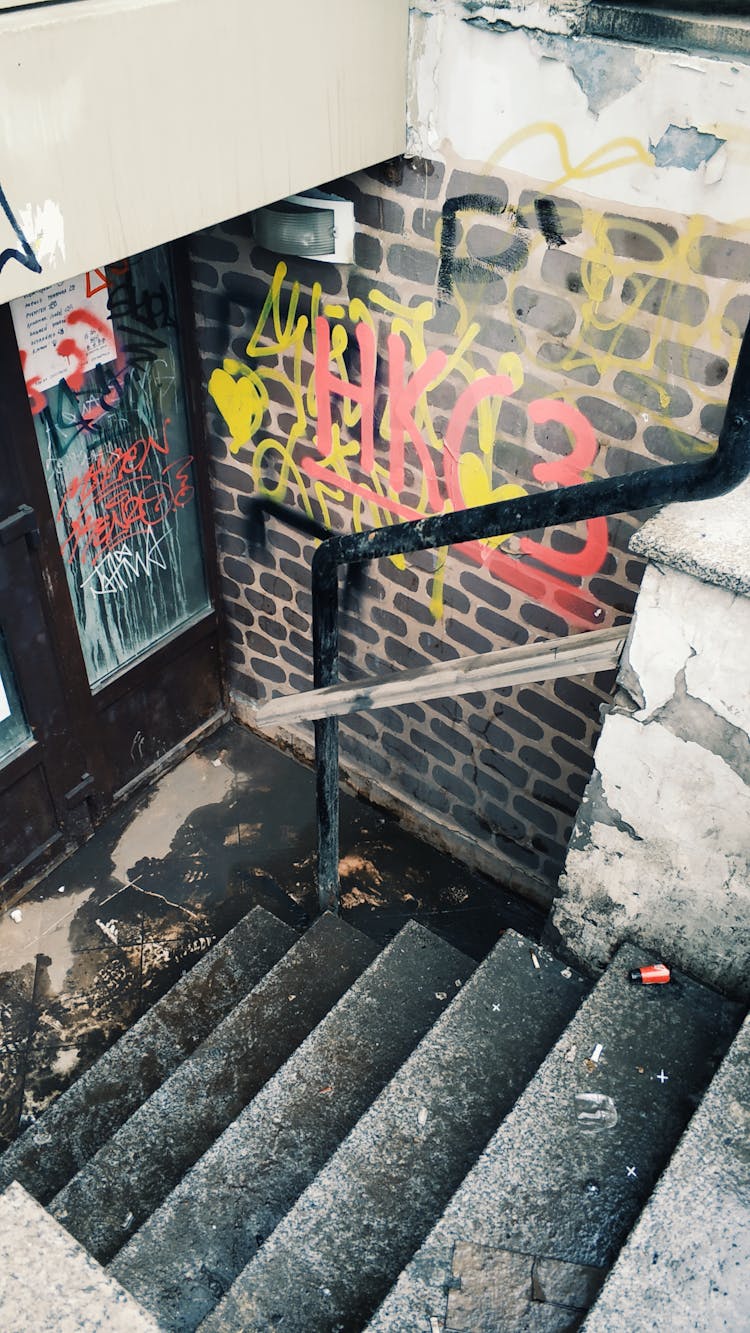 Dirty Stairs Near Brick Wall With Graffiti On Street