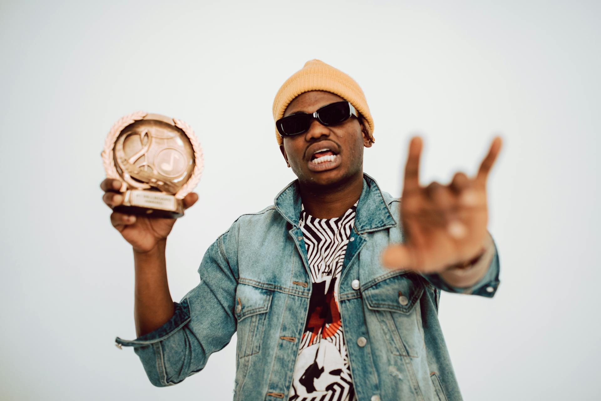 Man Holding His Award in Music