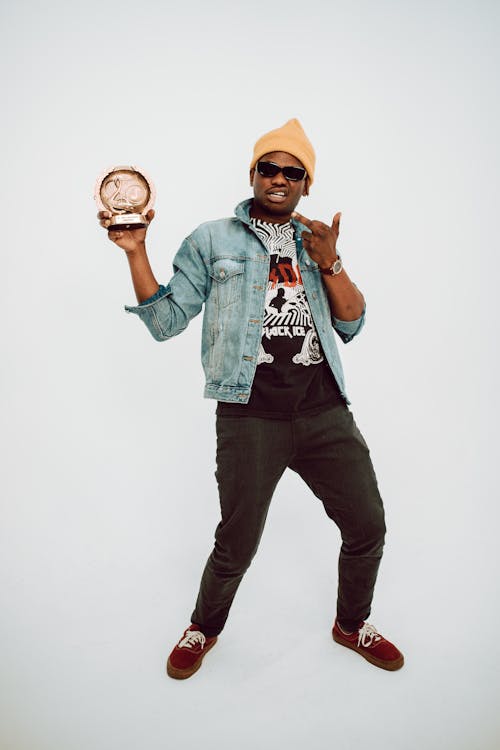 Free Man Posing with His Music Award Stock Photo