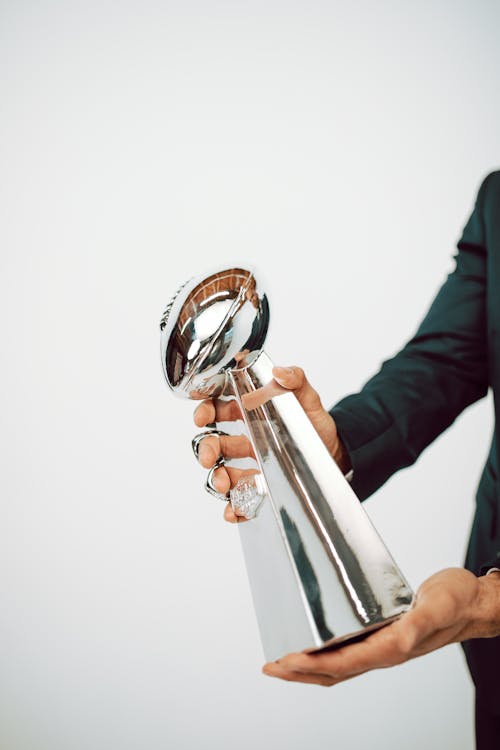 Free Hands Holding a Sliver Trophy Stock Photo