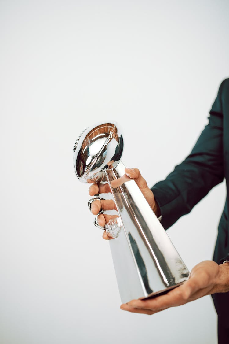 Hands Holding A Sliver Trophy