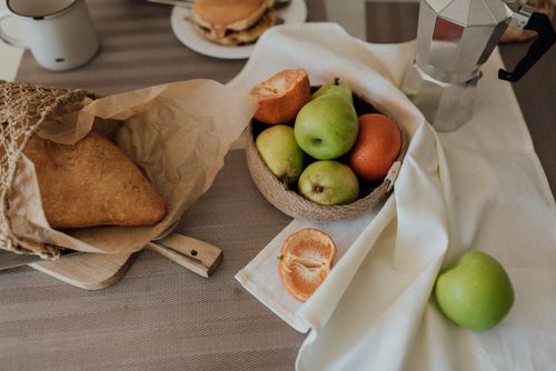 Free A cozy breakfast spread with fresh fruits, bread, and coffee for a relaxing start to the day. Stock Photo