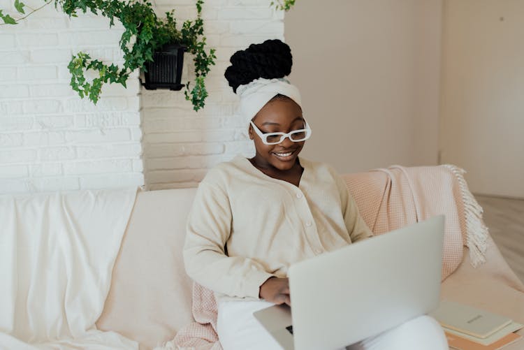 Woman Wearing Eyeglasses Using A Computer Laptop