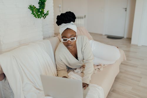 A Woman Using a Laptop on a Couch