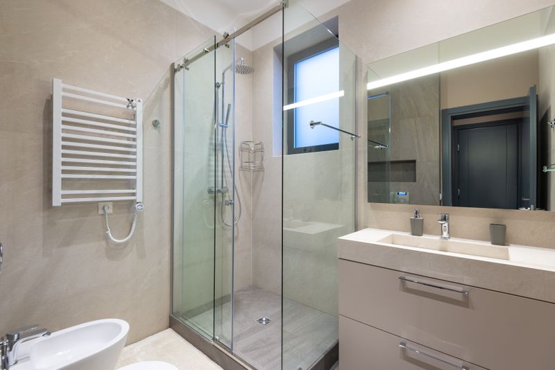 Limestone bathroom with tailored fixtures in a Miami renovation