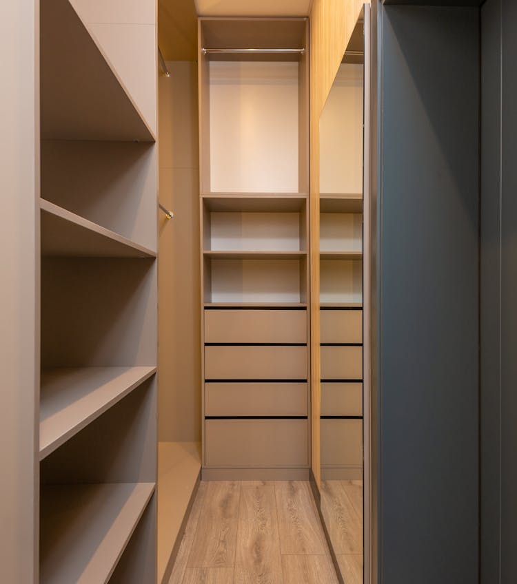 Minimalist Styled Empty Built In Closet With Racks And Shelves