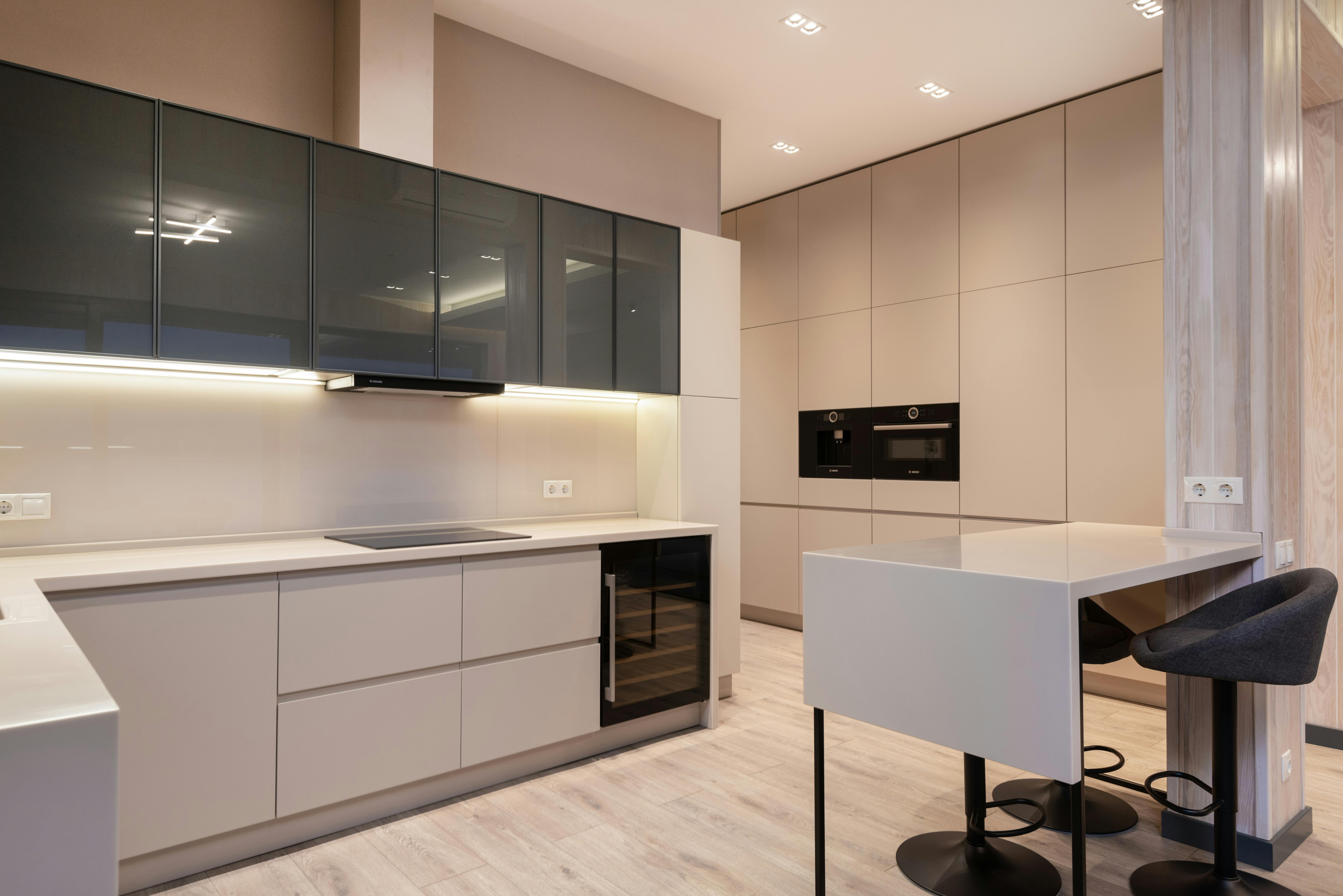 minimalist interior of spacious kitchen with modern furniture and appliances