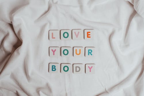 Phrase Love Your Body Made of Scrabble Pieces