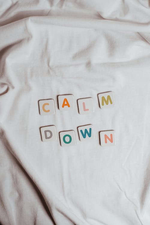 Free The Phrase Calm Down on a Sheet of Fabric Stock Photo