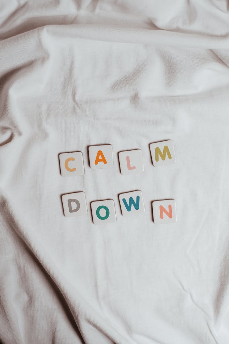 The Phrase Calm Down On A Sheet Of Fabric
