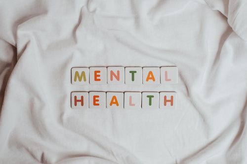 Free Close-up of 'Mental Health' text on cloth, symbolizing calmness and self-care. Stock Photo