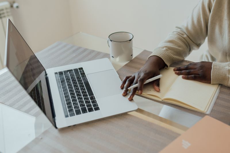 Person fact-checking AI-generated content on laptop — AI side hustle idea 2026