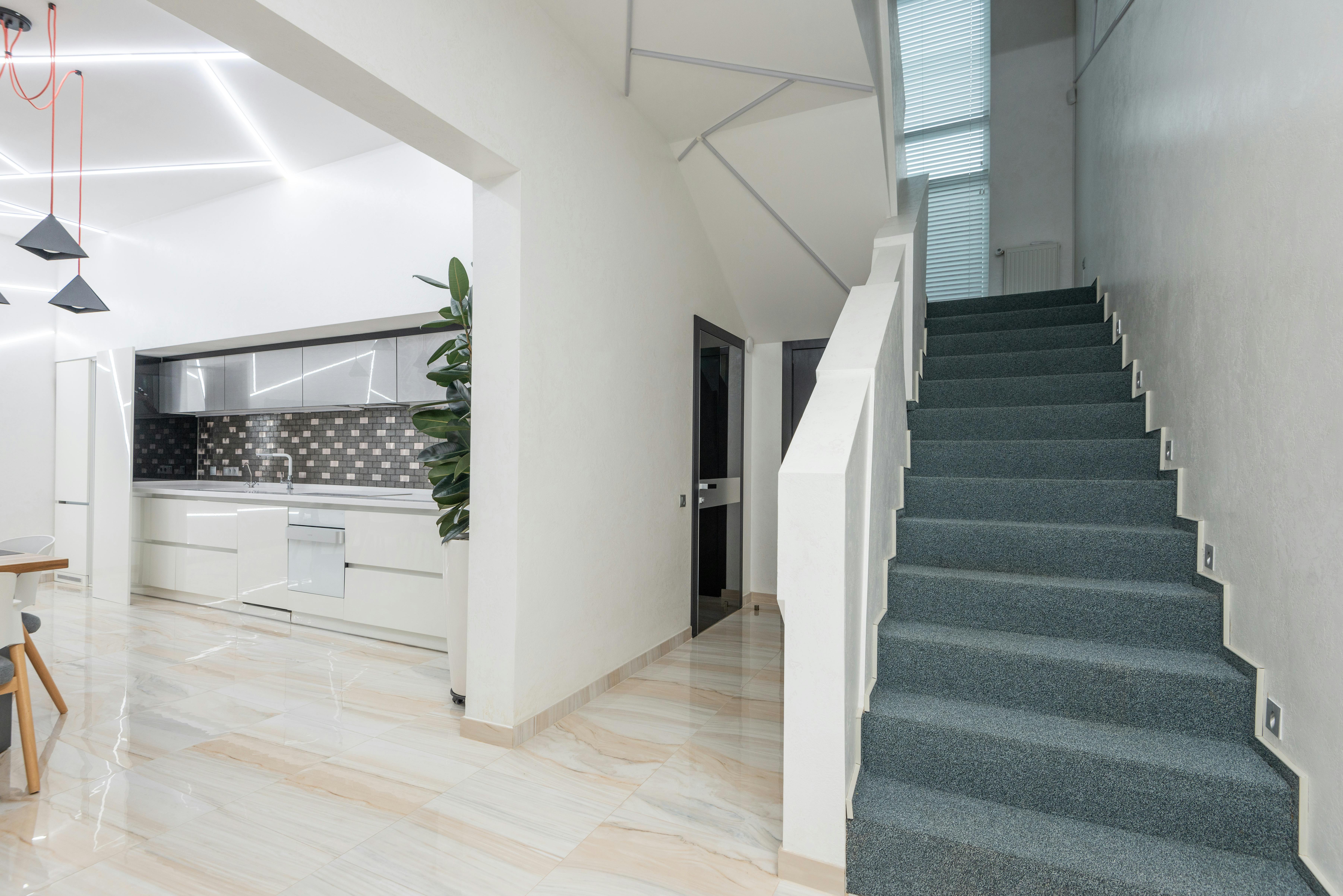 hallway with stairs in modern villa with spacious kitchen