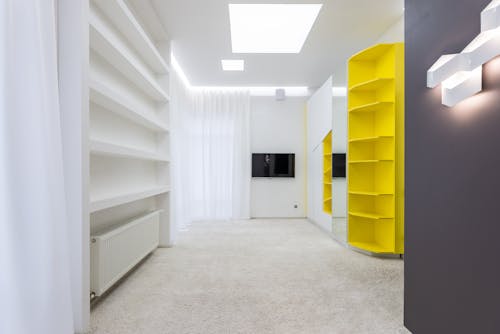 Interior of spacious empty room with new furniture and light walls in modern apartment