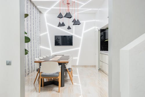 Interior of modern empty dining room with large table and light walls in daytime