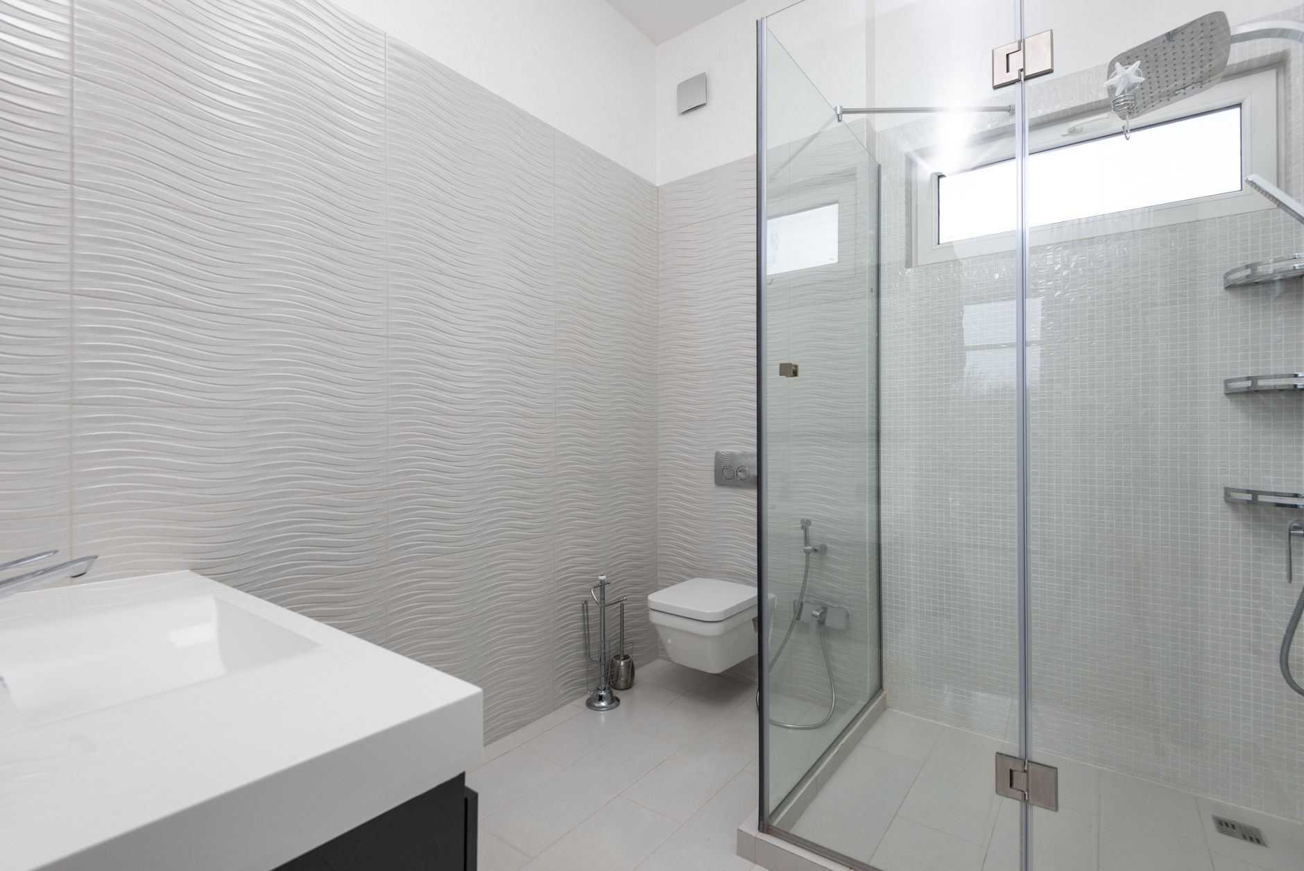 Bathroom Design Choices That Work in North Texas 2 Shower room with glass walls against toilet bowl and washbasin above tiled floor in light house