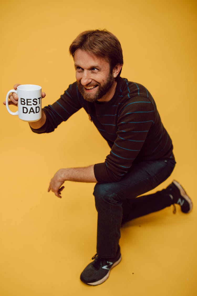 A Bearded Man Holding A Mug