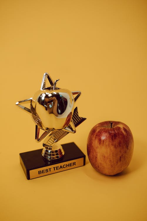 Free A Best Teacher Award beside an Apple Stock Photo