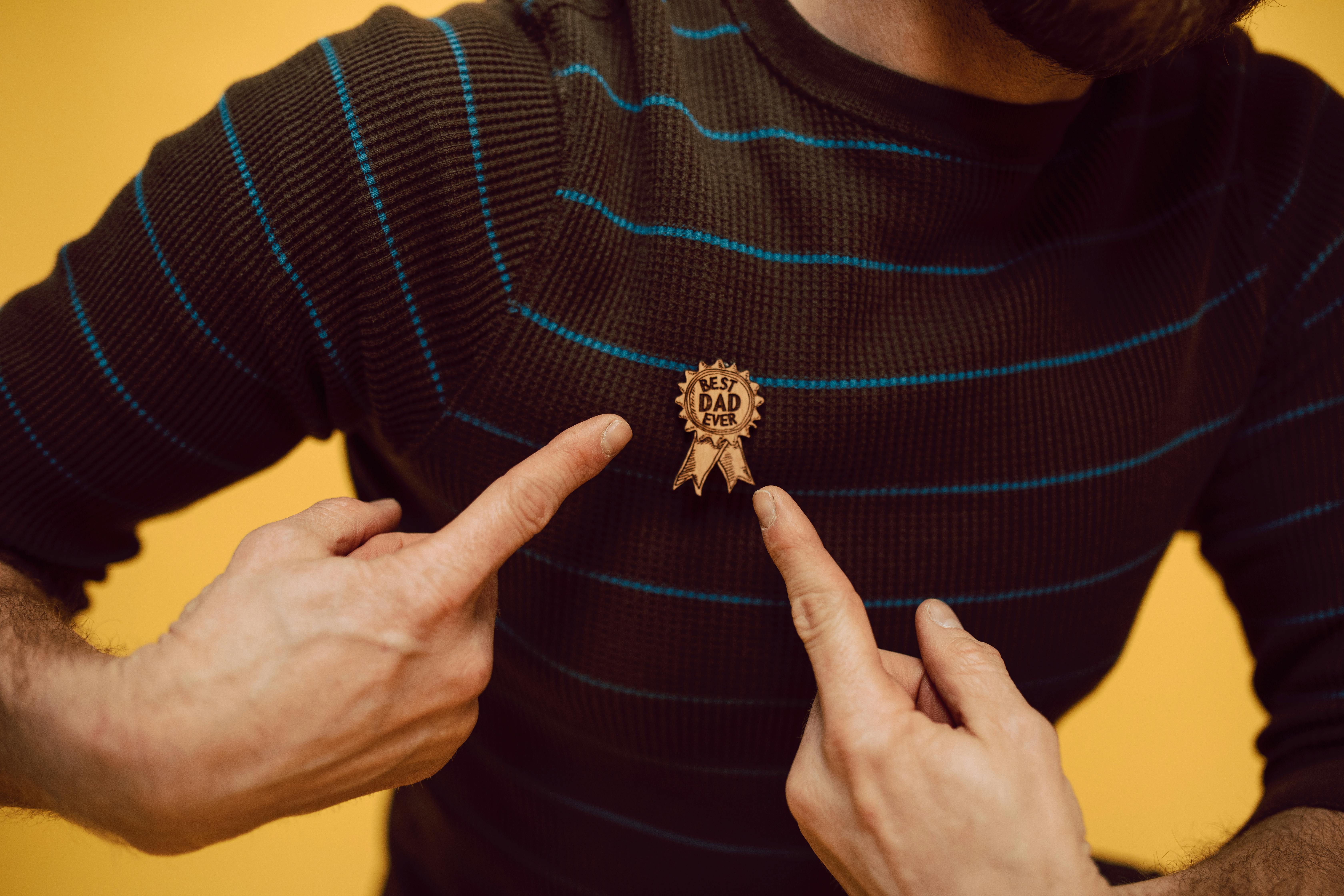 a man pointing a best dad ever pin