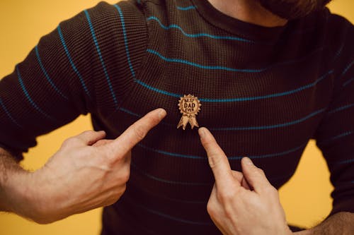 A Man Pointing a Best Dad Ever Pin