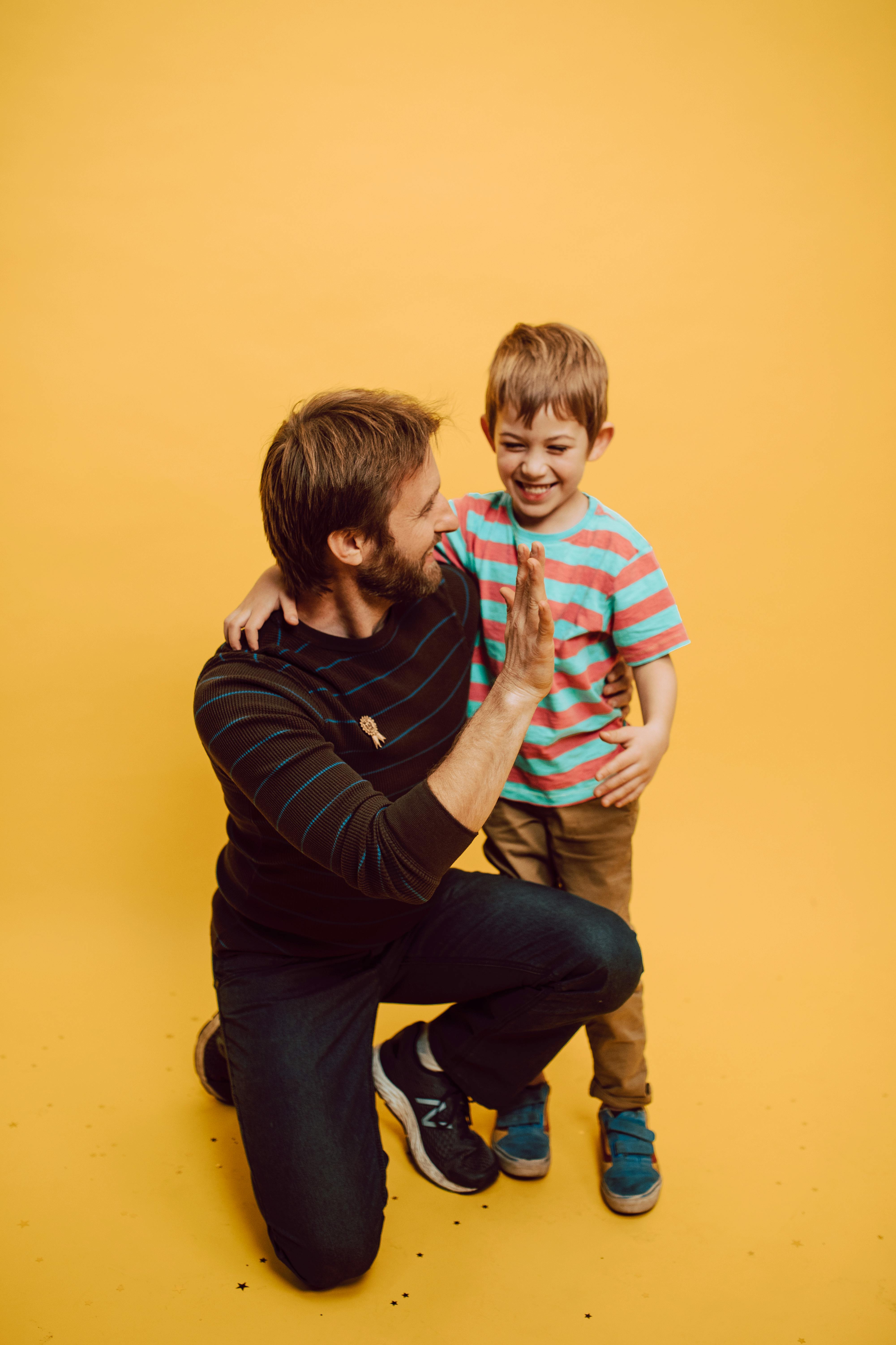 a father giving a high five to his son