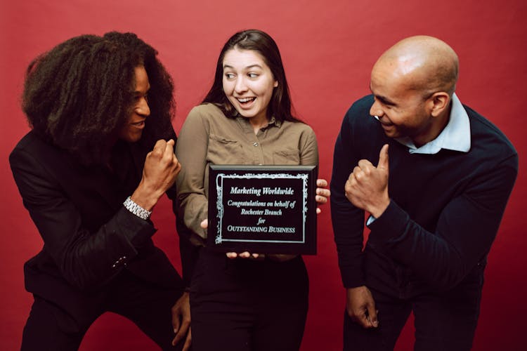 A Woman Holding A Recognition Award