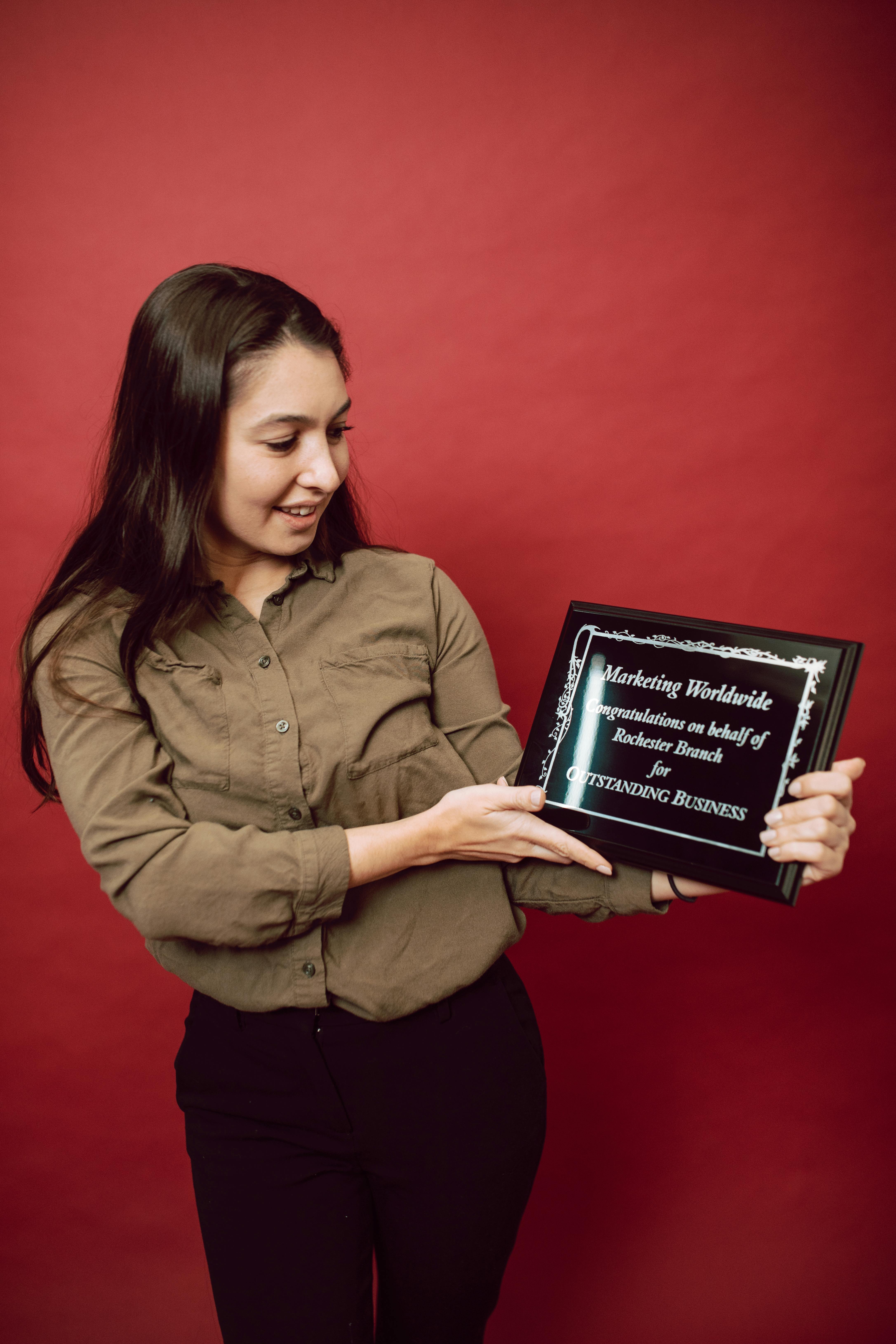 a businesswoman looking at her recognition award