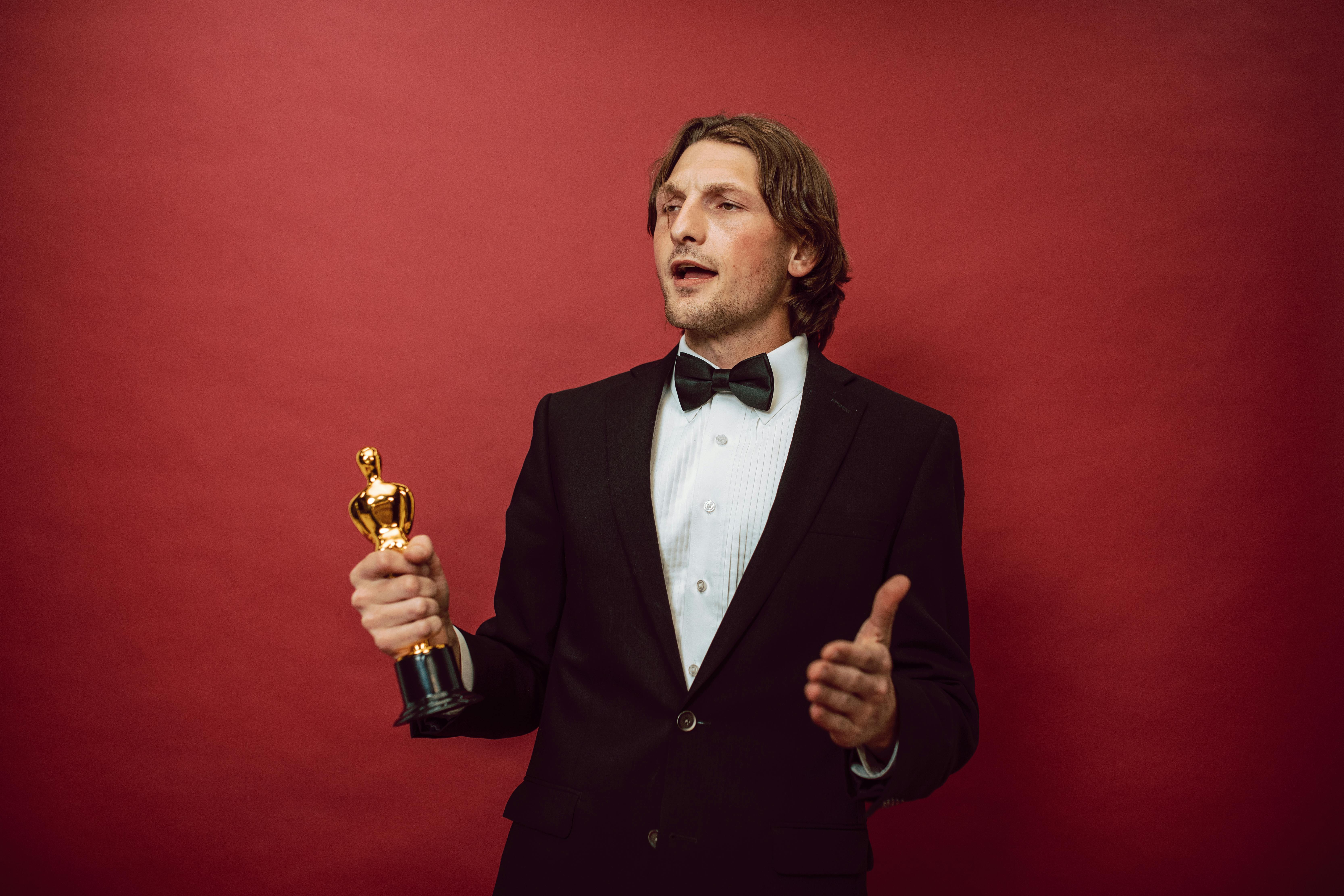 a proud man holding an award