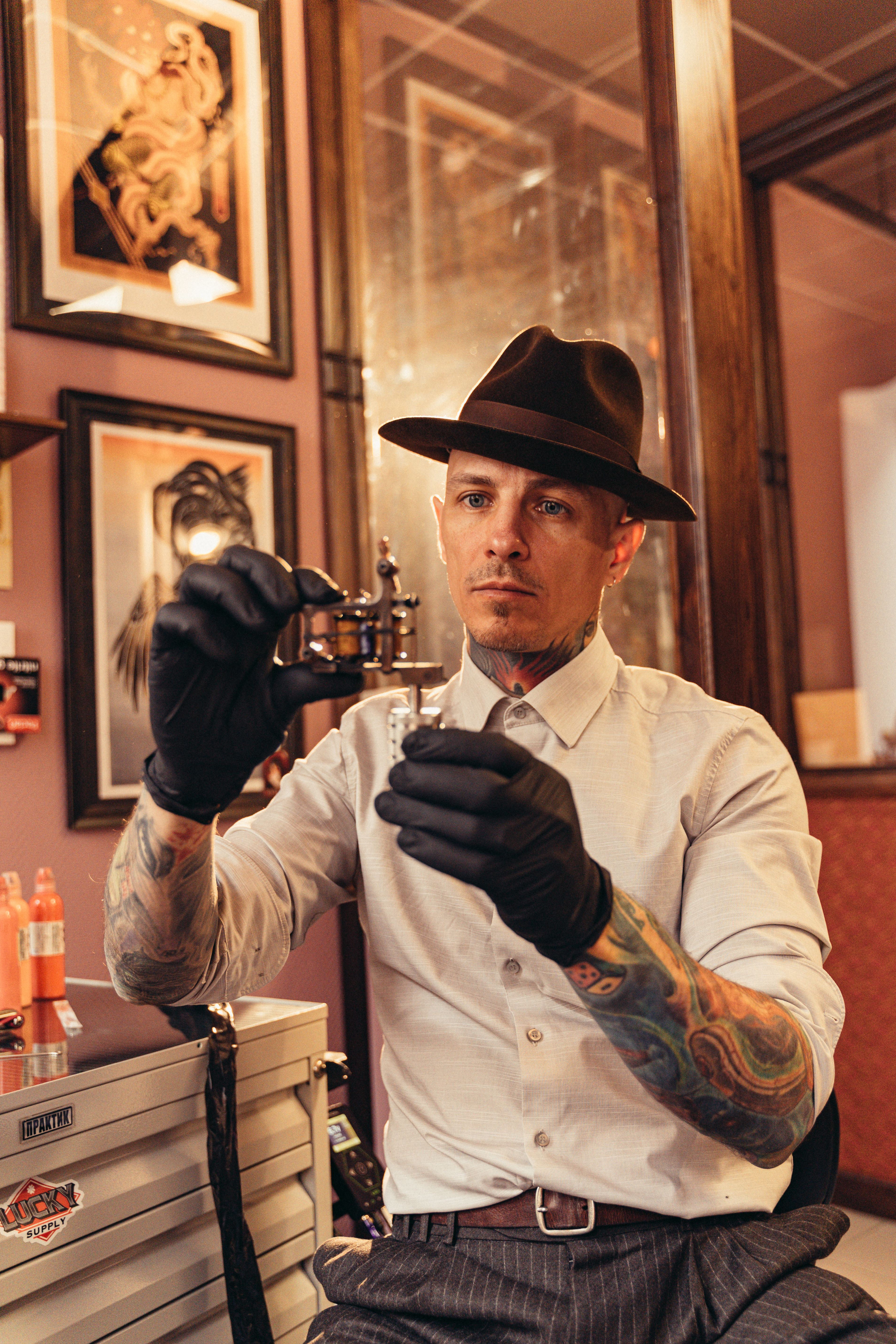 Professional tattoo artist preparing his equipment in a stylish studio setting.