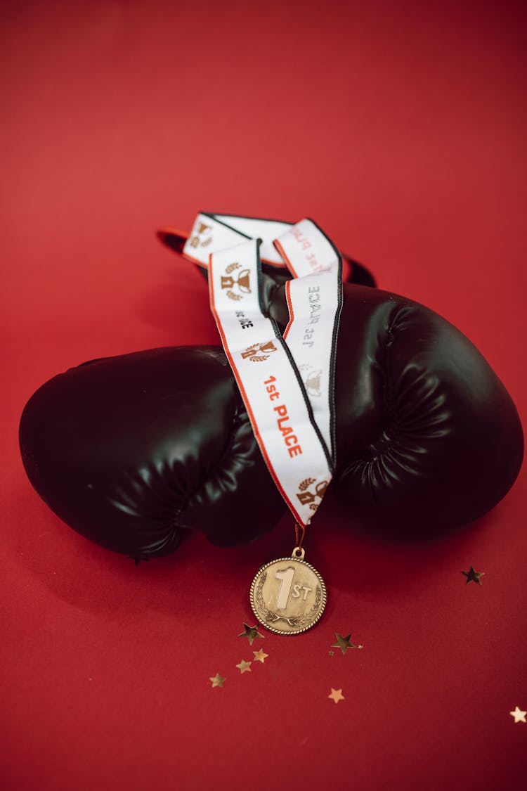 A Medal On Top Of Boxing Gloves