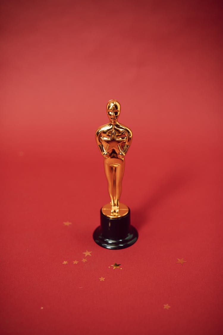 A Gold Trophy On Red Background