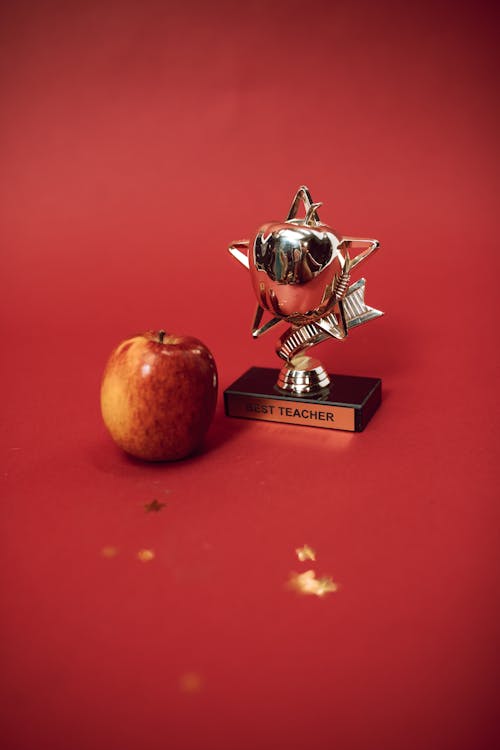 An Apple and a Best Teacher Trophy