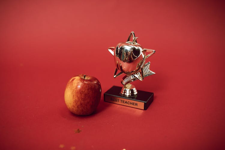 A Best Teacher Trophy And An Apple