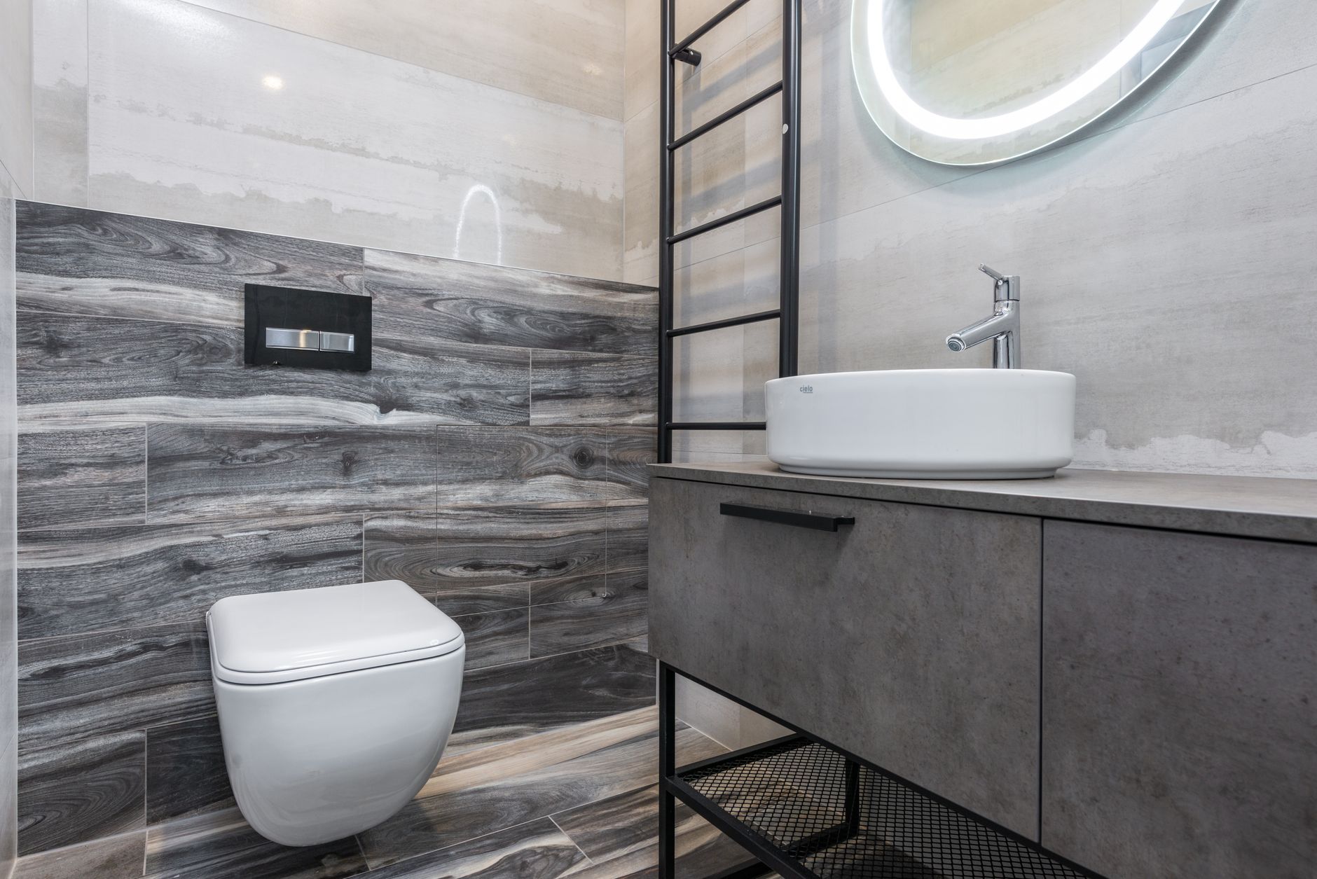 Bathroom Remodeling Trends and Tips for 2025 2 A sleek modern bathroom featuring gray tiles, a stylish sink, and a minimalist design