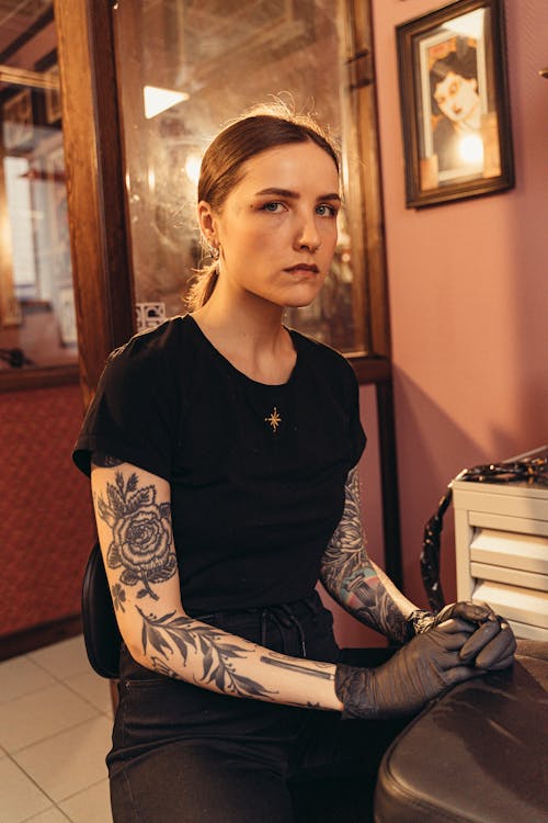 A Tattooed Woman in a Black Shirt