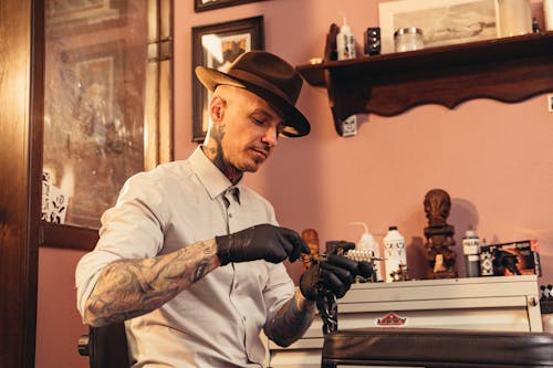 Free A Tattoo Artist Readying His Tattoo Machine Stock Photo