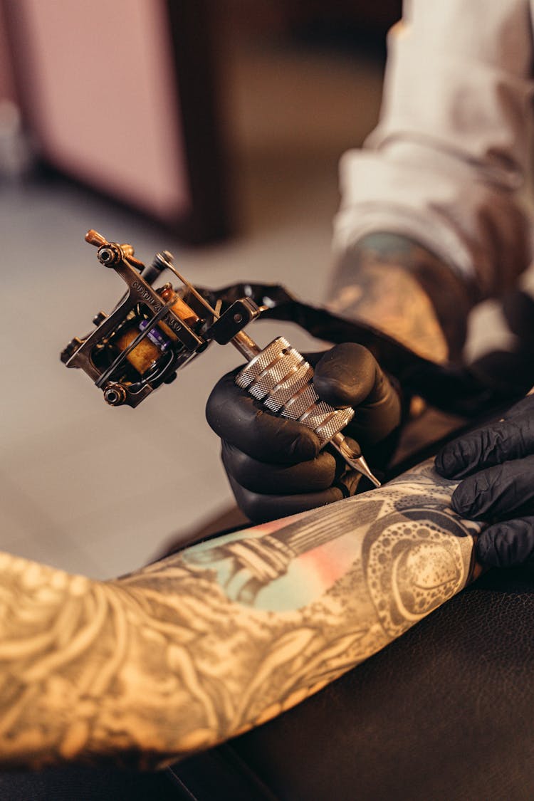 Tattoo Machine On A Client's Arm