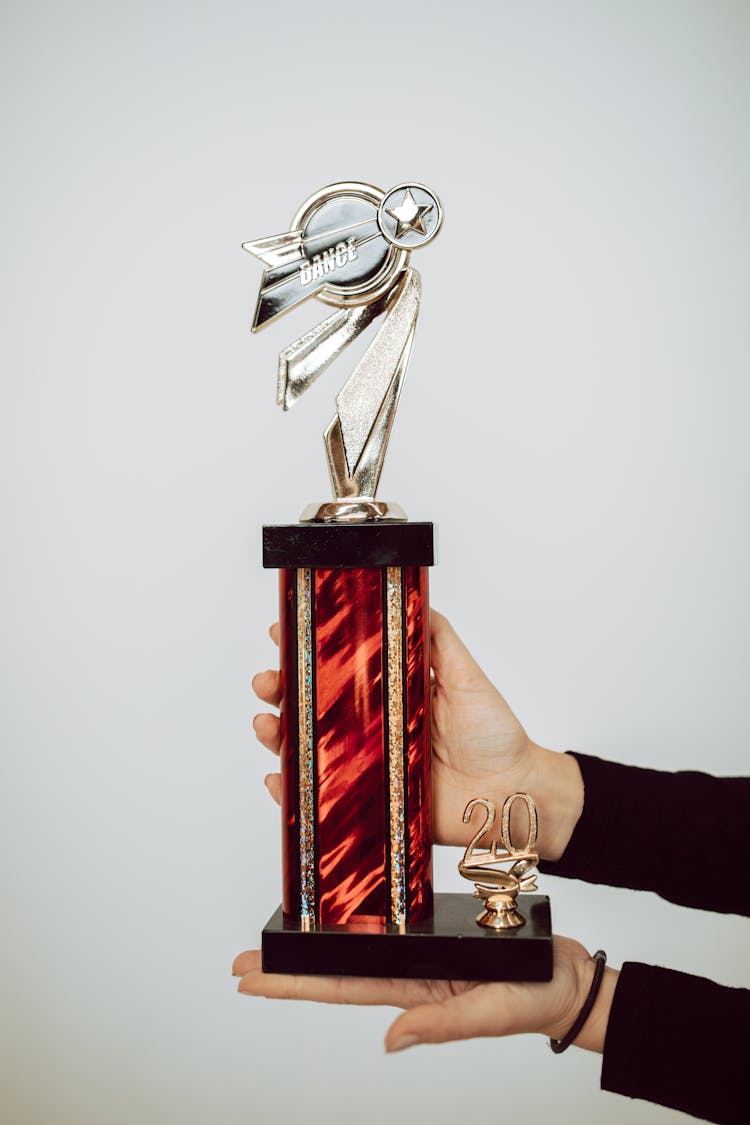 Close-Up Shot Of A Person Holding A Trophy