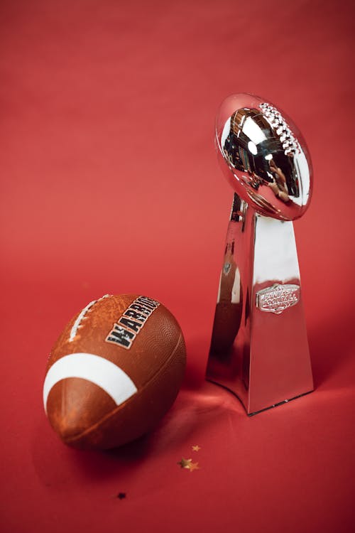 Free A Pigskin Football and a Silver Trophy Stock Photo