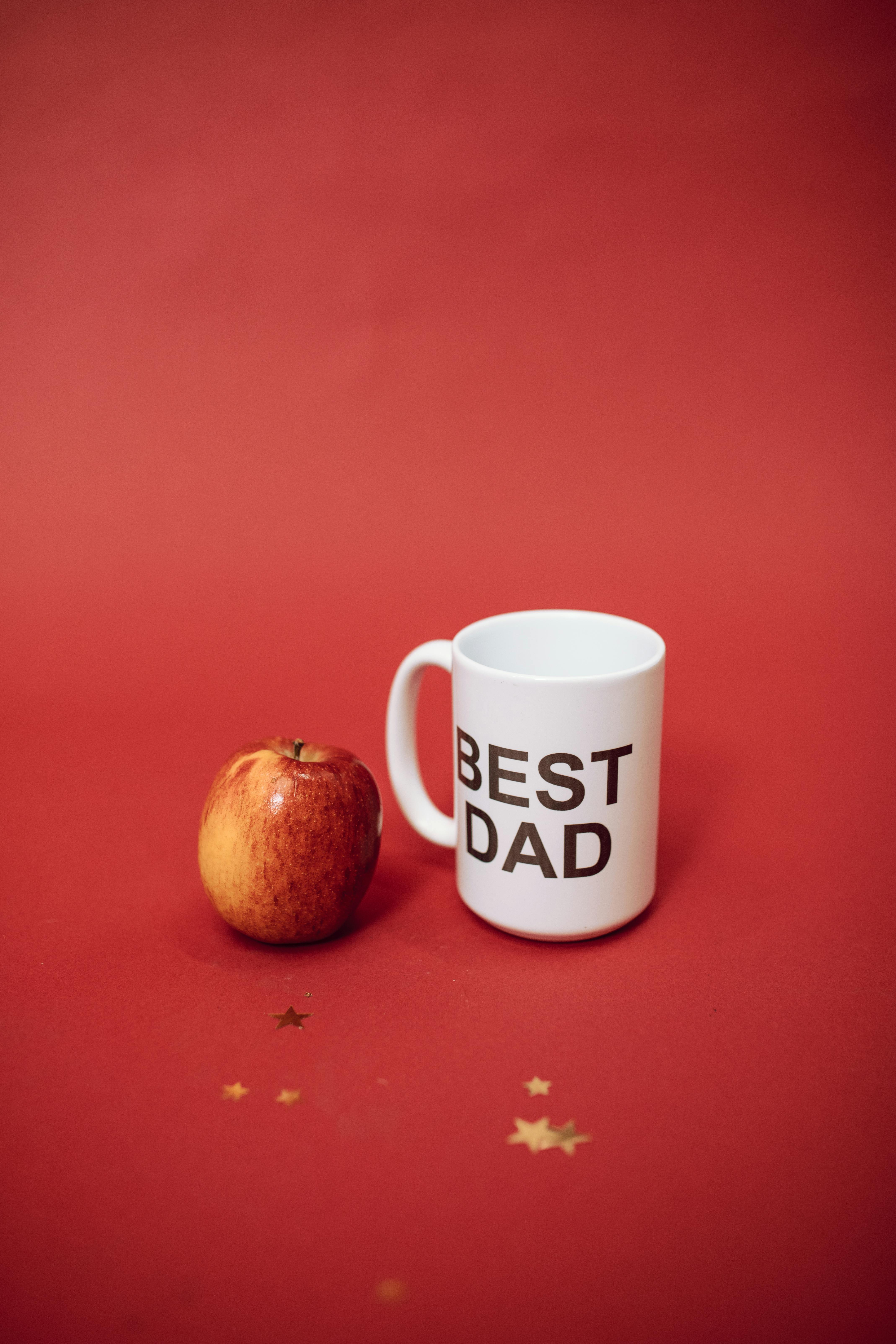 an apple beside a best dad mug