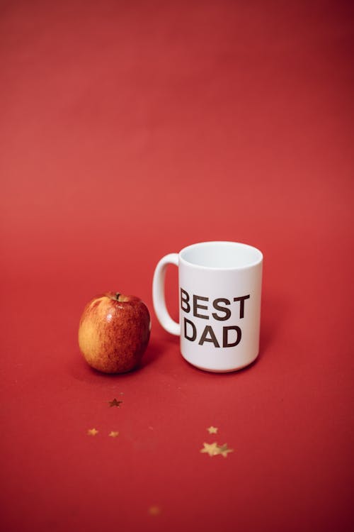 An Apple Beside a Best Dad Mug