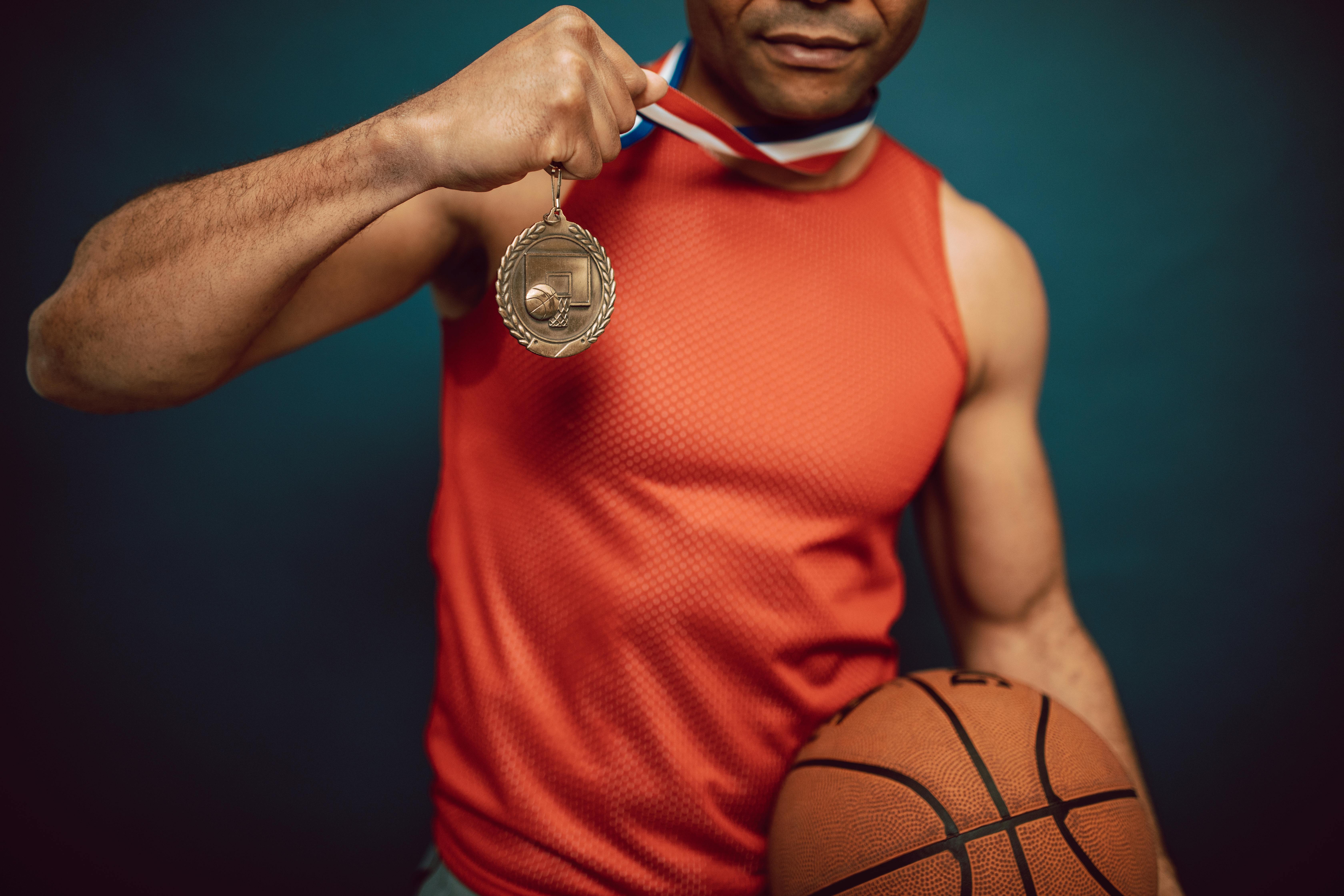 a proud man in a jersey showing a medal