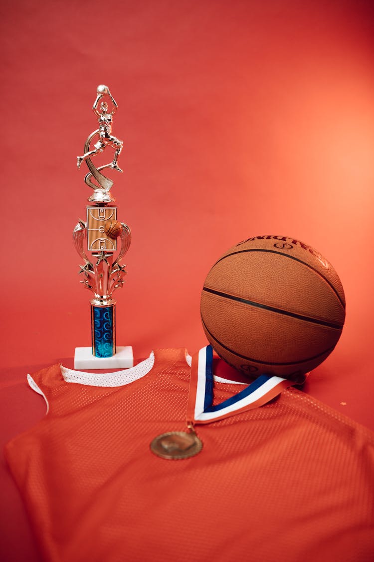 A Basketball And Trophy On The Table