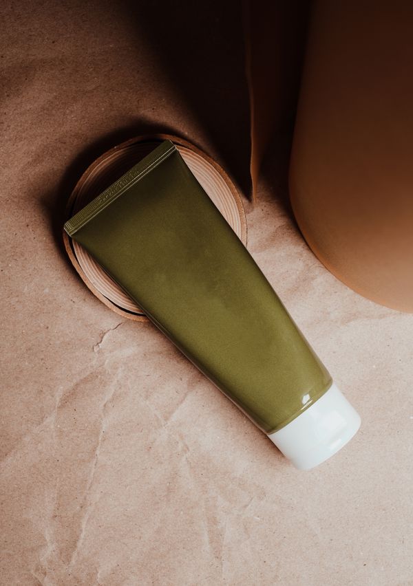 An unbranded skincare tube on a clay backdrop — photo by Vie Studio on Pexels