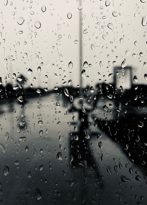 Free Close-up view of raindrops on a glass window with cityscape background in Ottawa. Stock Photo