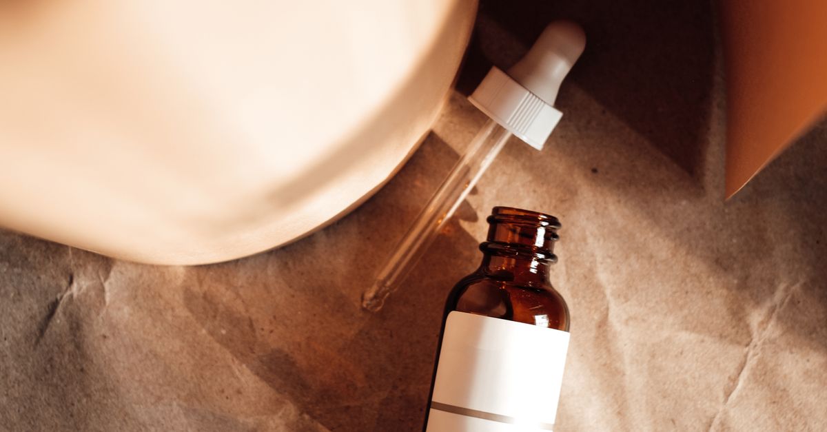 A Dropper and a Bottle on the Brown Paper · Free Stock Photo